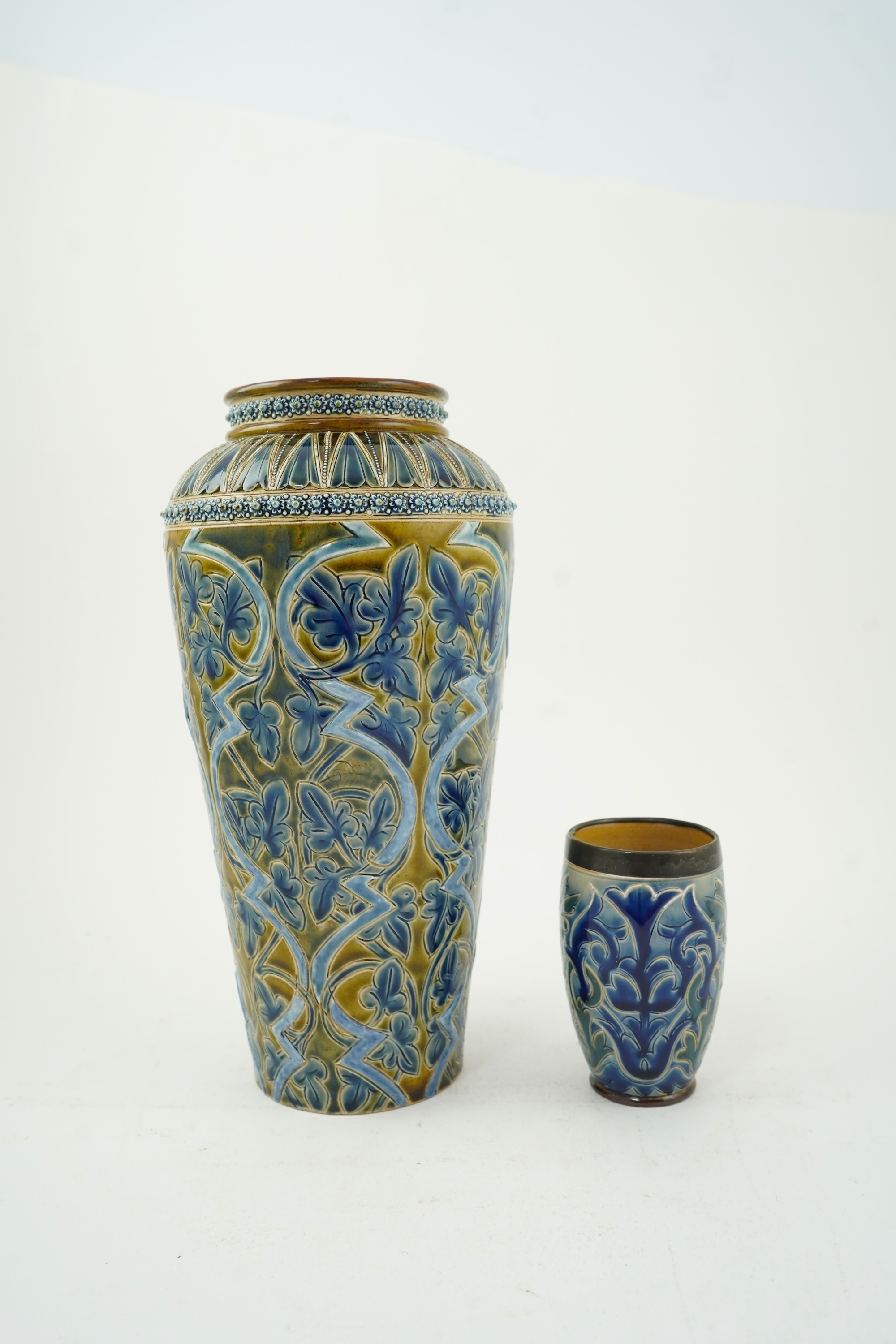 A Doulton Edith Lupton stoneware vase, drill hole to base, together with a similar Martha Rogers silver mounted cup, Tallest 31cm